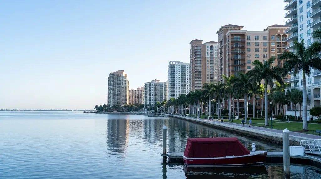 Residential high-rises along a bay in morning light.