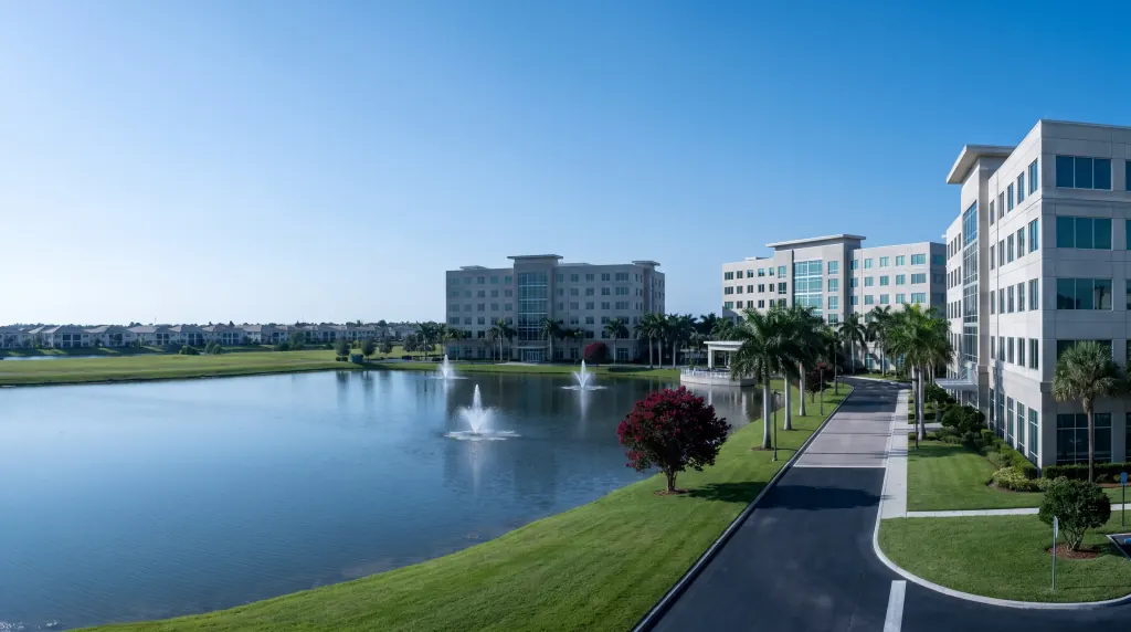Mid-rise hotels and offices around a lake in Central Florida.
